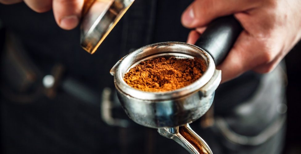 Barista,Holding,Portafilter,And,Coffee,Tamper,Making,An,Espresso,Coffee.
